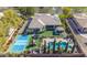 Stunning aerial view of the backyard featuring a pool, tennis court, outdoor kitchen, trampoline, and lush landscaping at 56 S Prairie Rd, Gilbert, AZ 85296