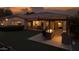 A covered outdoor kitchen, lawn, and a glimpse of the home's interior create an entertainer's dream at 56 S Prairie Rd, Gilbert, AZ 85296