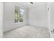 Bright bedroom featuring carpet floors, decorative wall trim, and a large window at 56 S Prairie Rd, Gilbert, AZ 85296