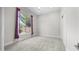 Bright bedroom featuring carpet floors, closet, and a large window at 56 S Prairie Rd, Gilbert, AZ 85296