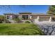 Charming stucco home featuring a well-manicured lawn and a spacious three car garage at 56 S Prairie Rd, Gilbert, AZ 85296