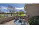 Relaxing patio with a water fountain, fire pit, seating, and decorative blue rug at 56 S Prairie Rd, Gilbert, AZ 85296