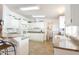 Bright kitchen featuring white cabinetry, modern appliances, a breakfast bar and tile flooring at 5735 E Mcdowell Rd # 447, Mesa, AZ 85215