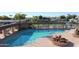 An elevated view of the community swimming pool with surrounding chairs and community landscaping at 5735 E Mcdowell Rd # 447, Mesa, AZ 85215