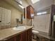 Bright bathroom with a large mirror, wood cabinets, and a shower-tub combo at 650 N Hawes Rd # 4508, Mesa, AZ 85207