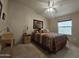 Bright bedroom with a ceiling fan, carpeted floor, and side tables at 650 N Hawes Rd # 4508, Mesa, AZ 85207