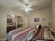 Comfortable secondary bedroom with a ceiling fan, carpeted floor, and closet at 650 N Hawes Rd # 4508, Mesa, AZ 85207