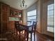 Cozy dining area with wood table and chairs, cabinet storage, and natural light from the window at 650 N Hawes Rd # 4508, Mesa, AZ 85207