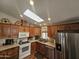 Well-lit kitchen with wooden cabinets, stainless steel appliances and a large skylight at 650 N Hawes Rd # 4508, Mesa, AZ 85207