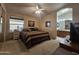 Comfortable main bedroom with a ceiling fan, carpeted floor, and private bathroom at 650 N Hawes Rd # 4508, Mesa, AZ 85207