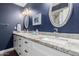 Elegant bathroom with dual sinks, granite countertops, decorative mirrors and modern fixtures at 6707 E Aire Libre Ln, Scottsdale, AZ 85254