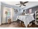 Charming bedroom features modern light fixtures, a large bed and wood-look flooring at 6707 E Aire Libre Ln, Scottsdale, AZ 85254