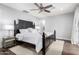 Primary bedroom with a king-size bed, ceiling fan, and wood floors at 6707 E Aire Libre Ln, Scottsdale, AZ 85254