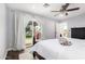 Primary bedroom with a dark wood bed frame, ceiling fan, and wood floors at 6707 E Aire Libre Ln, Scottsdale, AZ 85254