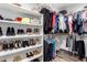 Walk-in closet offers ample storage with built-in shelving and hanging rods for organization at 6707 E Aire Libre Ln, Scottsdale, AZ 85254