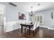 Elegant dining room with a dark wood table, decorative chandelier, and wainscotting at 6707 E Aire Libre Ln, Scottsdale, AZ 85254