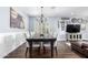 Dining room with a large table set for eight under a chandelier and wood flooring at 6707 E Aire Libre Ln, Scottsdale, AZ 85254