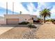 Single-story home with a desert-style rock garden and palm tree in a sunny suburban neighborhood at 6707 E Aire Libre Ln, Scottsdale, AZ 85254