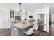 Modern kitchen with stainless steel appliances, an island, and stone countertops at 6707 E Aire Libre Ln, Scottsdale, AZ 85254