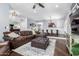 Spacious living room featuring a leather sectional, hardwood floors, bay window with shutters and neutral decor at 6707 E Aire Libre Ln, Scottsdale, AZ 85254