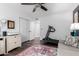 Bright room with a large dresser, white trim, wood floors, and a comfortable seating area at 6707 E Aire Libre Ln, Scottsdale, AZ 85254