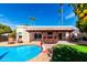 Beautiful backyard pool with covered patio, basketball hoop, and lush landscaping, perfect for relaxation and recreation at 6707 E Aire Libre Ln, Scottsdale, AZ 85254