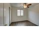 Cozy bedroom features a ceiling fan, wood-look flooring, and a window at 6709 S 49Th Dr, Laveen, AZ 85339