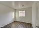 Minimalist bedroom features wood-look flooring, natural light, and neutral walls at 6709 S 49Th Dr, Laveen, AZ 85339