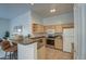 Well-lit kitchen featuring wood cabinetry, stainless appliances, and bar seating for casual dining at 6709 S 49Th Dr, Laveen, AZ 85339