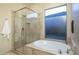 Bathroom with a shower, separate soaking tub, and a frosted window at 6993 E Soaring Eagle Way, Scottsdale, AZ 85266