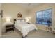 Cozy bedroom features a ceiling fan, neutral carpet, and a view of the desert landscape at 6993 E Soaring Eagle Way, Scottsdale, AZ 85266