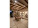 Covered patio with rustic chandelier, wood beam ceiling, and a table with chairs at 6993 E Soaring Eagle Way, Scottsdale, AZ 85266