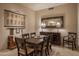 Dining room with decorative mirror, and a rustic wooden table set at 6993 E Soaring Eagle Way, Scottsdale, AZ 85266