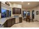 Well-lit kitchen with stainless steel appliances, dark wood cabinets, and breakfast nook at 6993 E Soaring Eagle Way, Scottsdale, AZ 85266