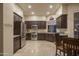 Spacious kitchen featuring stainless steel appliances and dark wood cabinets at 6993 E Soaring Eagle Way, Scottsdale, AZ 85266