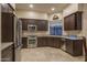 Stylish kitchen featuring stainless steel appliances, dark cabinetry, and granite countertops at 6993 E Soaring Eagle Way, Scottsdale, AZ 85266