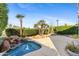 Inviting backyard with a rock waterfall flowing into a small pool, surrounded by manicured landscaping at 8100 E Camelback Rd # 43, Scottsdale, AZ 85251