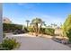 Serene backyard features a water feature, mature trees, and desert landscaping at 8100 E Camelback Rd # 43, Scottsdale, AZ 85251