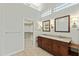 Bathroom featuring a double sink vanity, a separate room for the toilet, and a walk-in closet at 8100 E Camelback Rd # 43, Scottsdale, AZ 85251