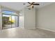 Bright bedroom features tile floors, ceiling fan, and sliding glass doors to a private patio at 8100 E Camelback Rd # 43, Scottsdale, AZ 85251