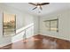 Sun-filled bedroom with hardwood floors, ceiling fan and two large windows offering bright light at 8100 E Camelback Rd # 43, Scottsdale, AZ 85251