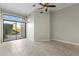 Bright bedroom features tile floors, ceiling fan, and sliding glass doors to a private patio at 8100 E Camelback Rd # 43, Scottsdale, AZ 85251