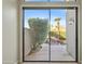 A view from inside a bedroom out onto the backyard patio with waterfall feature at 8100 E Camelback Rd # 43, Scottsdale, AZ 85251