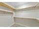 Walk-in closet featuring shelves and wooden rods, perfect for organizing clothes and accessories at 8100 E Camelback Rd # 43, Scottsdale, AZ 85251