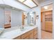 Bright bathroom featuring a marble countertop, decorative mirror, and ample cabinet space at 8147 E Lakeview Ave, Mesa, AZ 85209