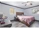 Bright bedroom featuring wood floors, a ceiling fan, and natural light at 921 S Val Vista Dr # 59, Mesa, AZ 85204