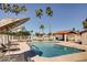 Community pool with lounge chairs and shade featuring a clear blue swimming area at 921 S Val Vista Dr # 59, Mesa, AZ 85204