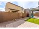 Low-maintenance backyard featuring artificial grass, a patio, and a view of the home's exterior at 9303 E Static Ave, Mesa, AZ 85212