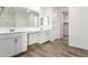 Bright bathroom with a double vanity and wood look tile at 9303 E Static Ave, Mesa, AZ 85212