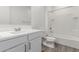 Well-lit bathroom features a shower-tub combo with white tiling and modern fixtures at 9303 E Static Ave, Mesa, AZ 85212